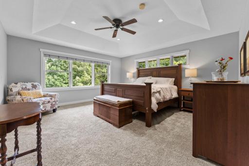 Upstairs, you’ll find four bedrooms, including a spacious primary suite featuring carpeting, elegant tray ceilings, and a large window.