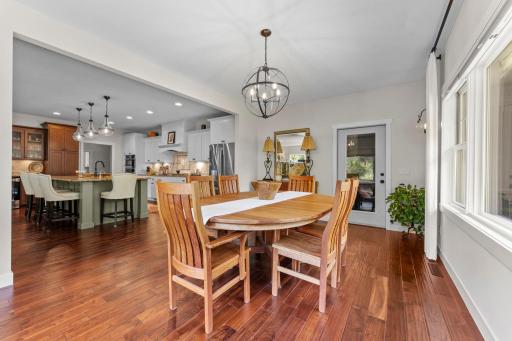 A modern chandelier adds an elegant touch, while access to the inviting 3-season porch creates an easy connection to additional living space.
