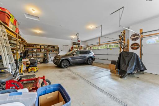A standout feature of this home is the oversized attached 4-car garage, complete with heated floors, floor drains, and hot and cold running water.
