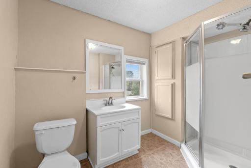 Unit 2 bathroom is clean and neat with standing shower.
