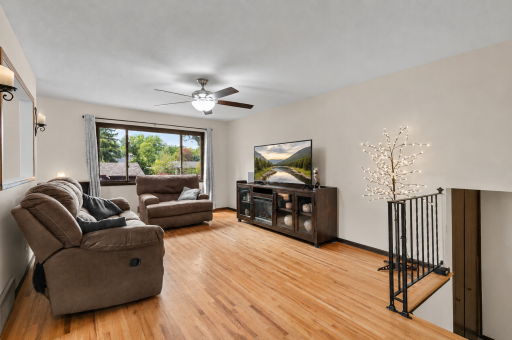 Bright & inviting living room featuring beautiful hardwood floors and abundant natural light!