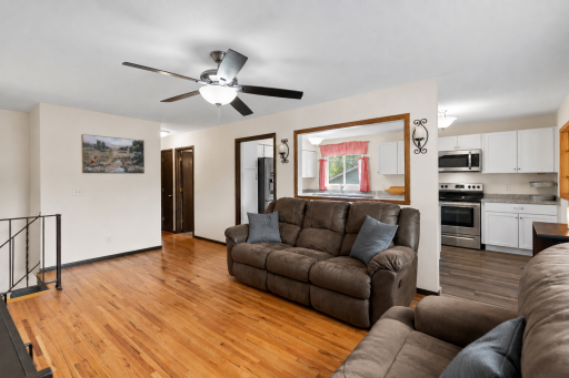 Spacious & bright living room featuring gorgeous hardwood floors and an open flow to the beautifully updated kitchen!