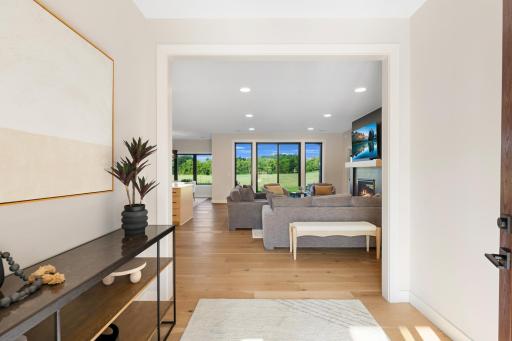 Gorgeous white oak floors creat a warm, elegant transition into the heart of the home.