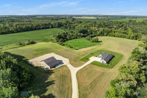 27.5 serene acres surrounded by mature tree, meandering creek and Alfalfa fields.
