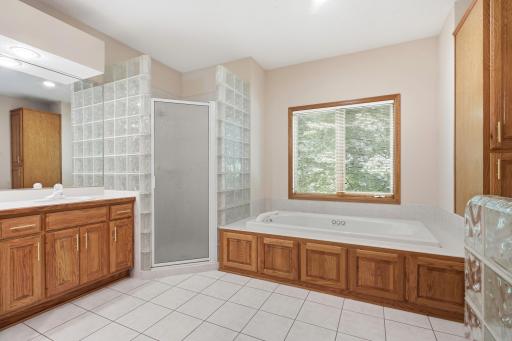 Another view of primary bath showing whirlpool tub, and ceramic floors
