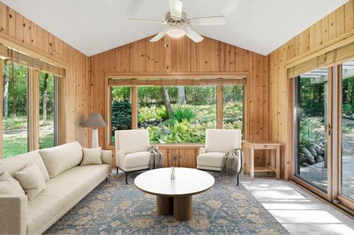 (virtual staged) Beautiful 4 season sun room with picture window overlooking wooded and private back yard. Knotty pine walls, walkout to huge private deck