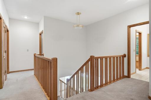 Upper level shows a nice hallway area leading to primary bedroom and 3 other good size bedrooms, plus a full bath with divided vanities