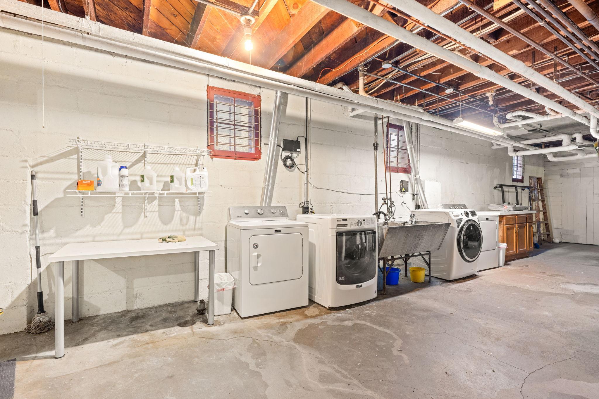 Two sets of shared washer/dryers in the basement