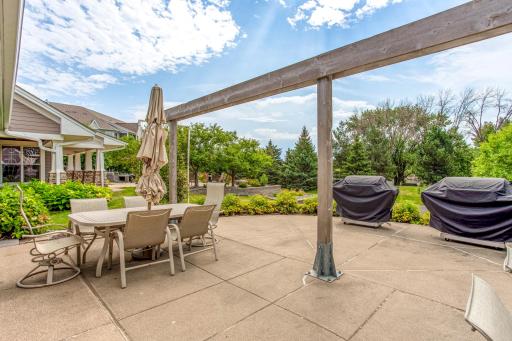 Spacious shared patio offers plenty of room for outdoor dining, grilling, and gathering with neighbors and guests.