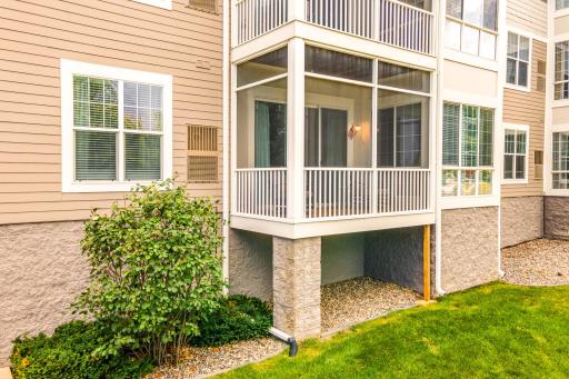 First floor condo unit featuring a screened-in porch extending the living space outdoors while overlooking the beautifully maintained community grounds.