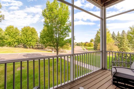 Relax on the screened-in porch while enjoying peaceful views of the surrounding green space and mature trees.