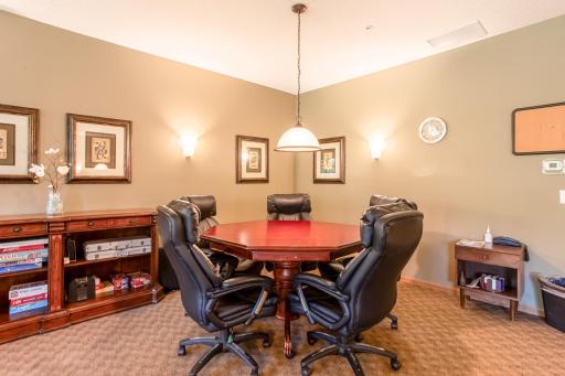 Gather around the game table for cards, board games, and friendly competition in this comfortable resident game room.