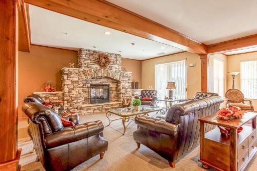 Relax and unwind beside the striking stone fireplace in one of the buildingâs inviting resident lounge areas.