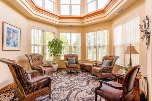 light-filled seating area with large windows and skylights provides a cheerful setting for community socializing and activities.