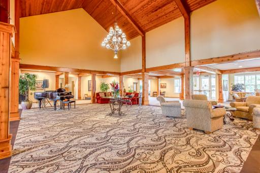 An impressive lodge-inspired lobby welcomes residents and guests with soaring wood ceilings, exposed beams, and multiple comfortable gathering areas.