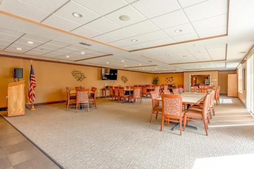 Host a crowd with ease in the generously sized party room, featuring multiple dining and gathering areas.