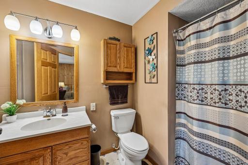 Convenient lower-level bathroom adds functionality to the finished living space.