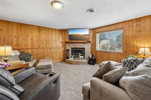Wood-burning fireplace creates a warm and inviting focal point.