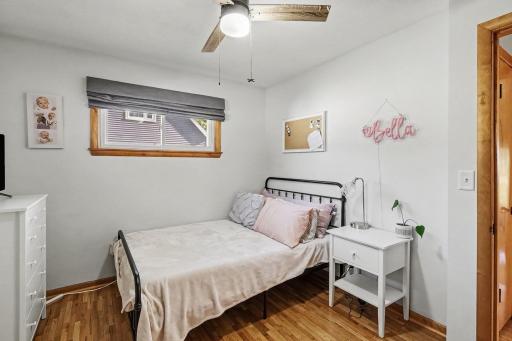 Main-level second bedroom with hardwood floors and closet space.