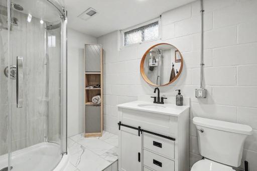 Updated lower-level 3/4 bath with modern shower and vanity.