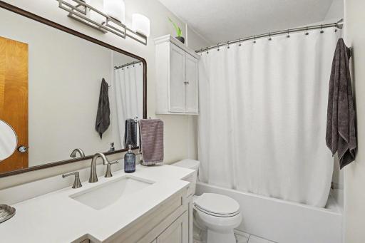 Main-level full bath with updated vanity and clean finishes.