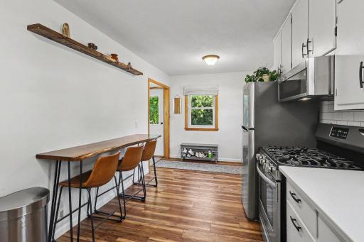 Kitchen dining area with updated flooring and everyday seating space.