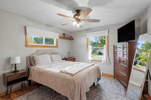 Main-level primary bedroom with hardwood floors and natural light.