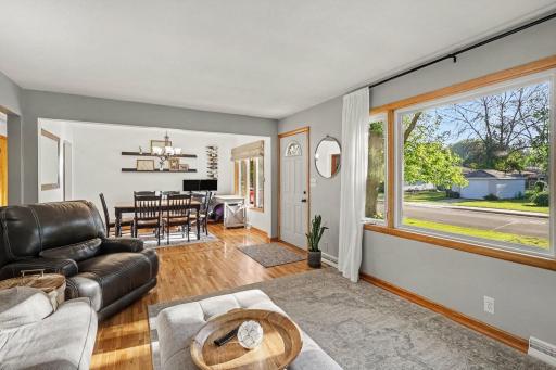 Alternate view of the living room showing front entry and connection to the dining room.
