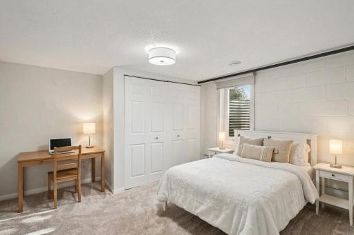 Lower-level fourth bedroom, virtually staged to show layout and use of space.