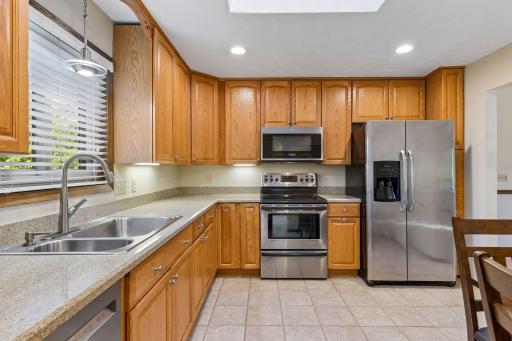 Another view of the kitchen workspace, highlighting the bright window over the double sink!