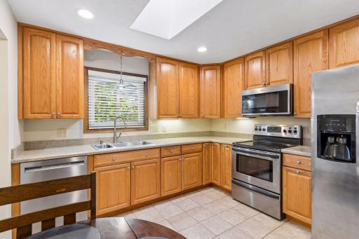 Another look at the kitchen, showcasing modern stainless steel appliances and abundant counter space!