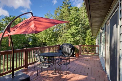 Expansive raised deck offering plenty of room for outdoor dining, grilling, and relaxing beneath a large patio umbrella!