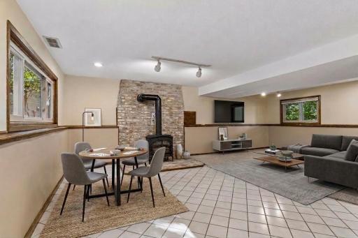 Large lower level family room and hearth area offering incredible layout flexibility for a media zone, game table, and cozy lounge spaces. *Virtually staged to show design options.
