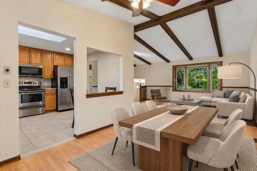 Another angle of the expansive open layout, beautifully capturing the new bay window, high wood-beamed ceilings, and bright living space! *Virtually staged to show design options.
