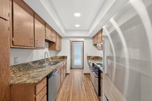 Efficient kitchen with granite countertops and stainless steel appliances