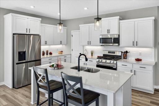 PHOTO OF A DIFFERENT HOME WITH SIMILAR PLAN AND FINISHES.