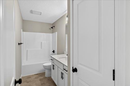 PHOTO OF A DIFFERENT HOME WITH SIMILAR PLAN AND FINISHES. Upper Full Bathroom.