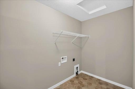 PHOTO OF A DIFFERENT HOME WITH SIMILAR PLAN AND FINISHES. Upper Floor Laundry Room.
