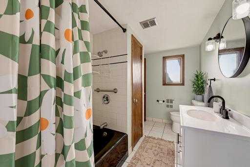 The full bathroom features tile floors and a linen closet.