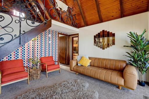 The living room features vaulted ceilings.