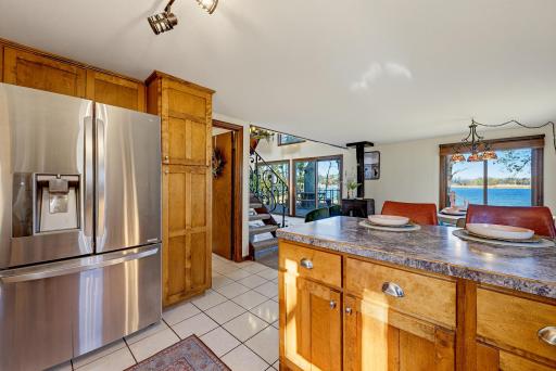The beautiful custom wood cabinets include a pantry with pull out drawers.