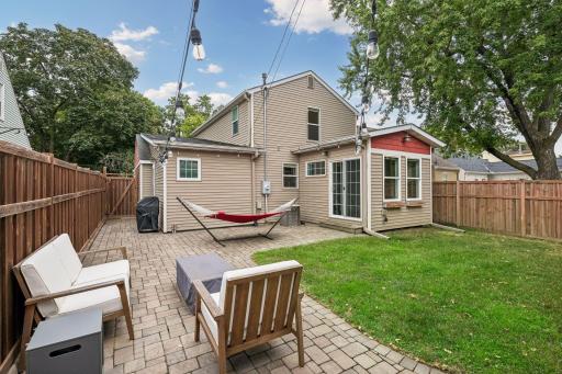 The sunroom walks out to a fabulous paver patio and private, fenced backyard.