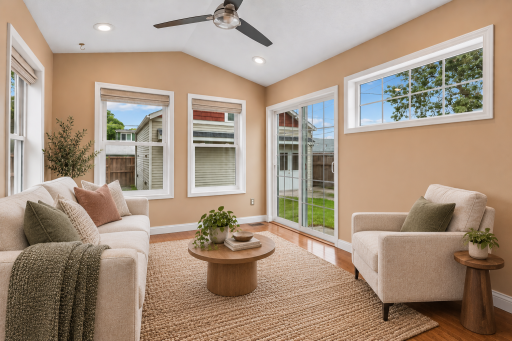 Light-filled sunroom with direct access to the backyard and patio. (Virtually staged)