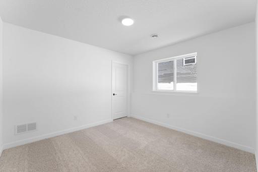 (Photo of a similar home, actual finishes may vary) This fourth bedroom is well-suited to accommodating overnight guests or visiting family members