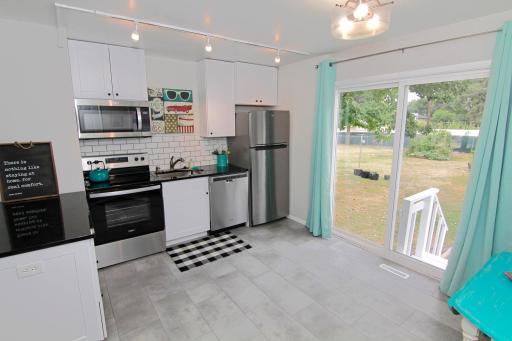 Updated kitchen with SS appliance and tile back splash.