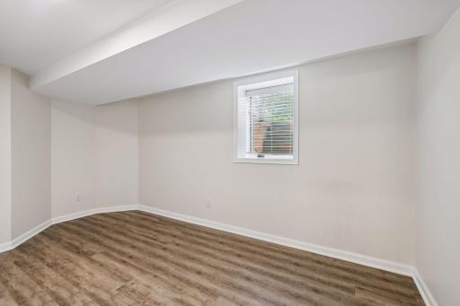 5th bedroom in lower level offers convenient guest space-they get their own level