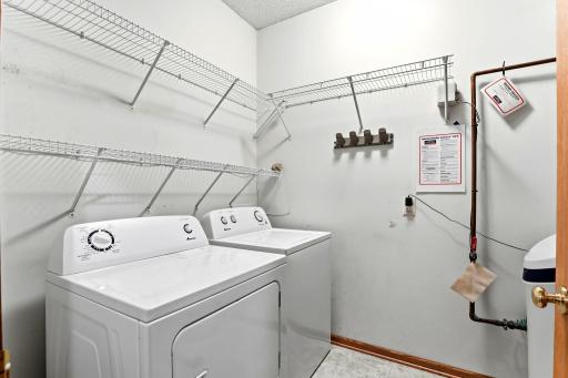 Wire shelving wraps the laundry room, with room above the washer and dryer for detergent, baskets, and everything else that needs a home.