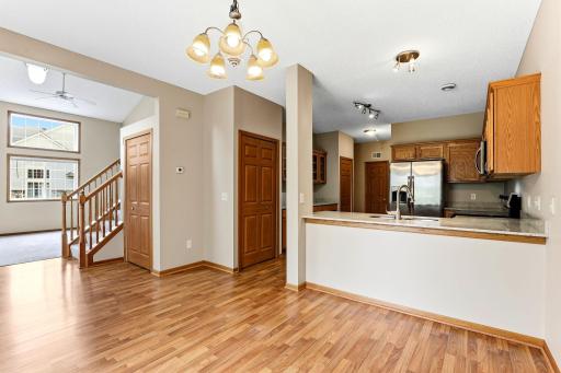 The main level flows from dining room to kitchen to great room, with laminate flooring throughout, a breakfast bar, and a coat closet right where you need it.