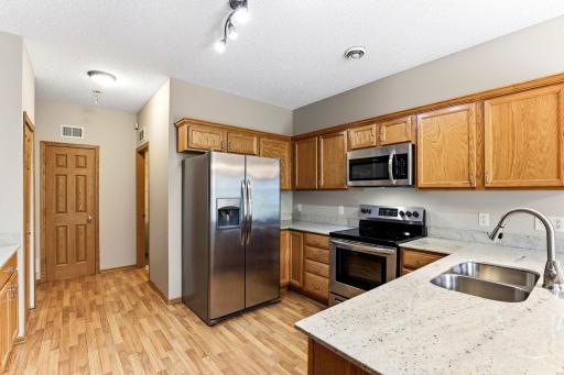 Stainless appliances, granite counters, and a full wall of oak cabinets give the kitchen a clean, updated feel with plenty of prep space.
