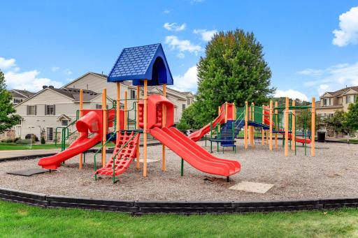A colorful community playground with slides, climbers, and a covered tower gives kids a place to play close to home.
